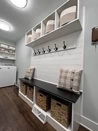 Laundry room with bench and cabinet spaces.