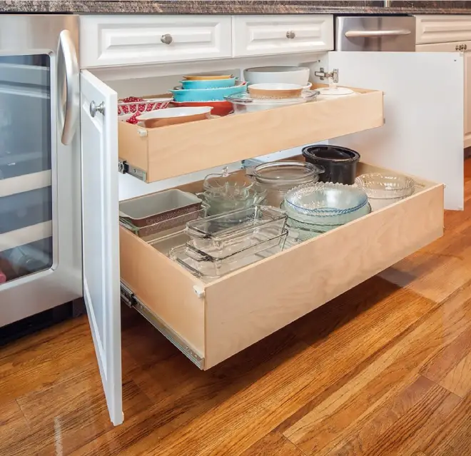 Kitchen under counter cabinets full of items.