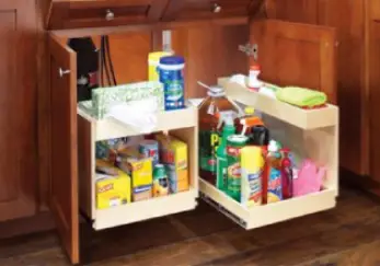 Under-sink kitchen Pull Out shelves with cleaning products on them.