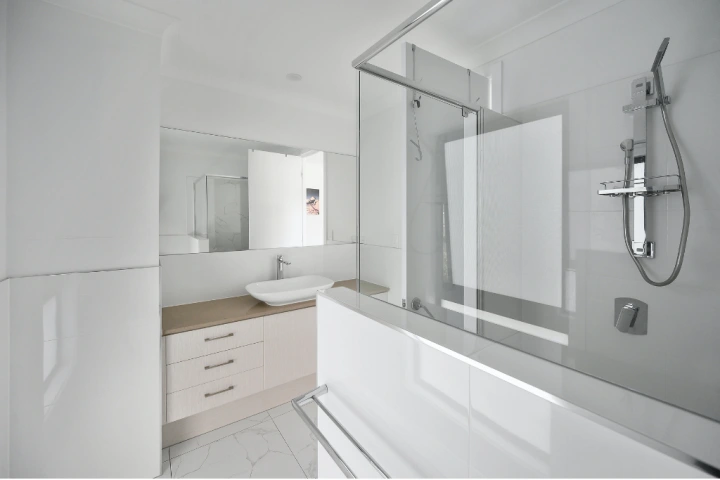 modern white bathroom with minimal glass shower cubicle