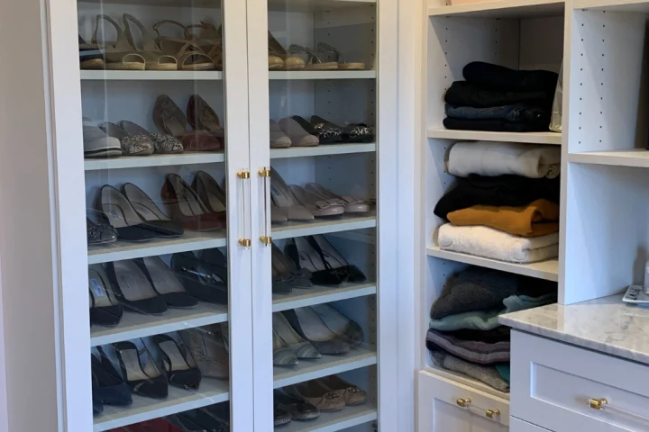 Custom ShelfGenie shelving holding shoes in a closet.