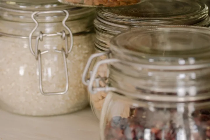 A group of glass jars with different types of food.