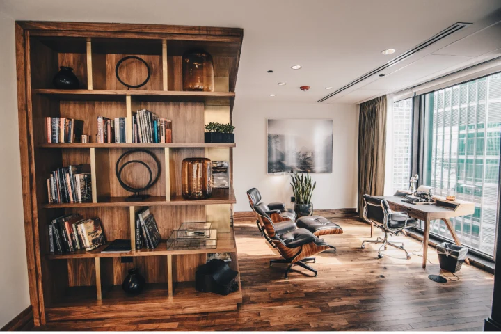 A room with a bookshelf and a desk.