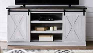 A tv stand with a sliding door.