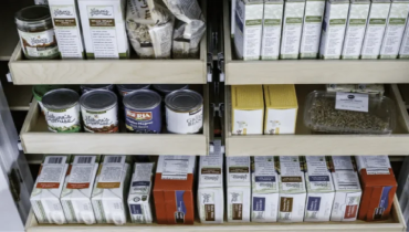 Shelves with boxes and cans on them.