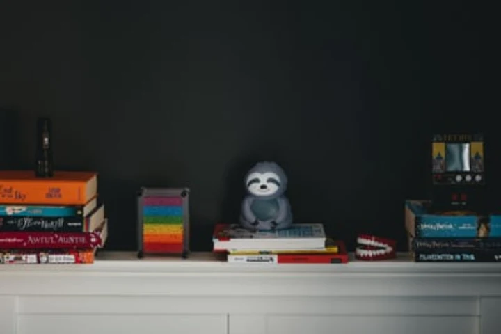 Books stacked on a mantle top.