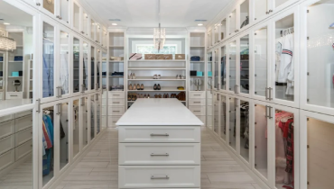 A white room with a white table and white shelves.