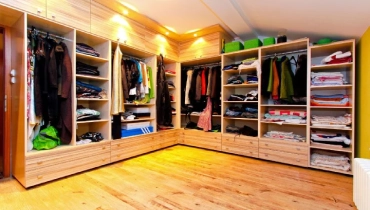 Wardrobe full of clothes.